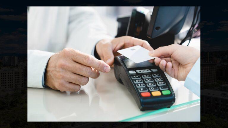 A credit card is held to a contactless checkout